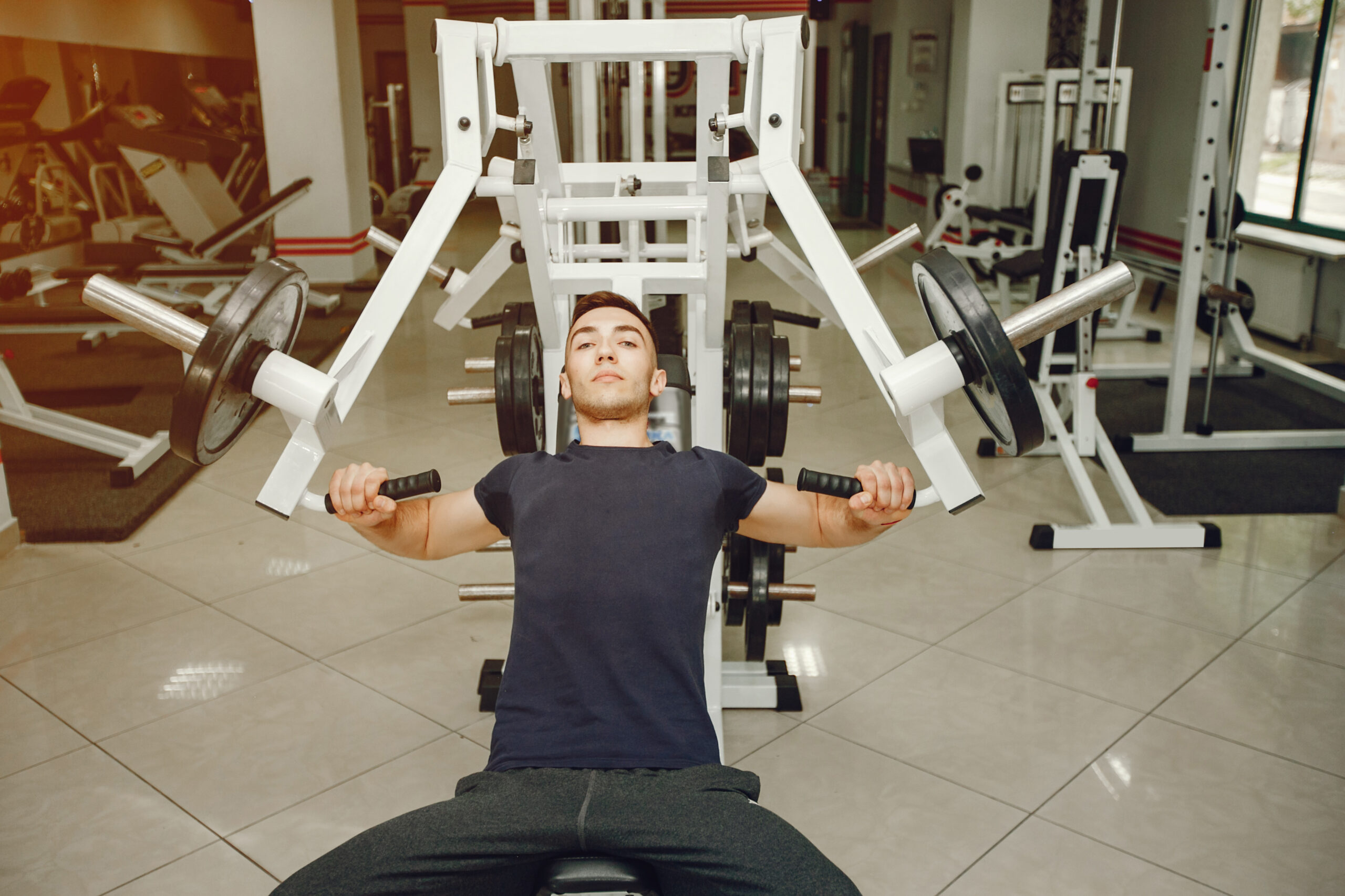 Man in a gym. Guy training. Male in a sportswear